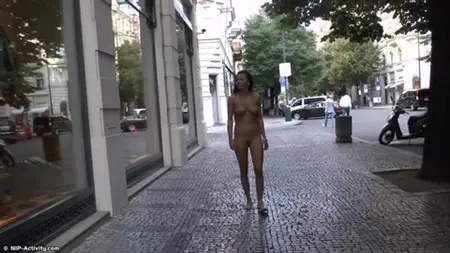 Caminata de una morena desnuda en el centro de la ciudad